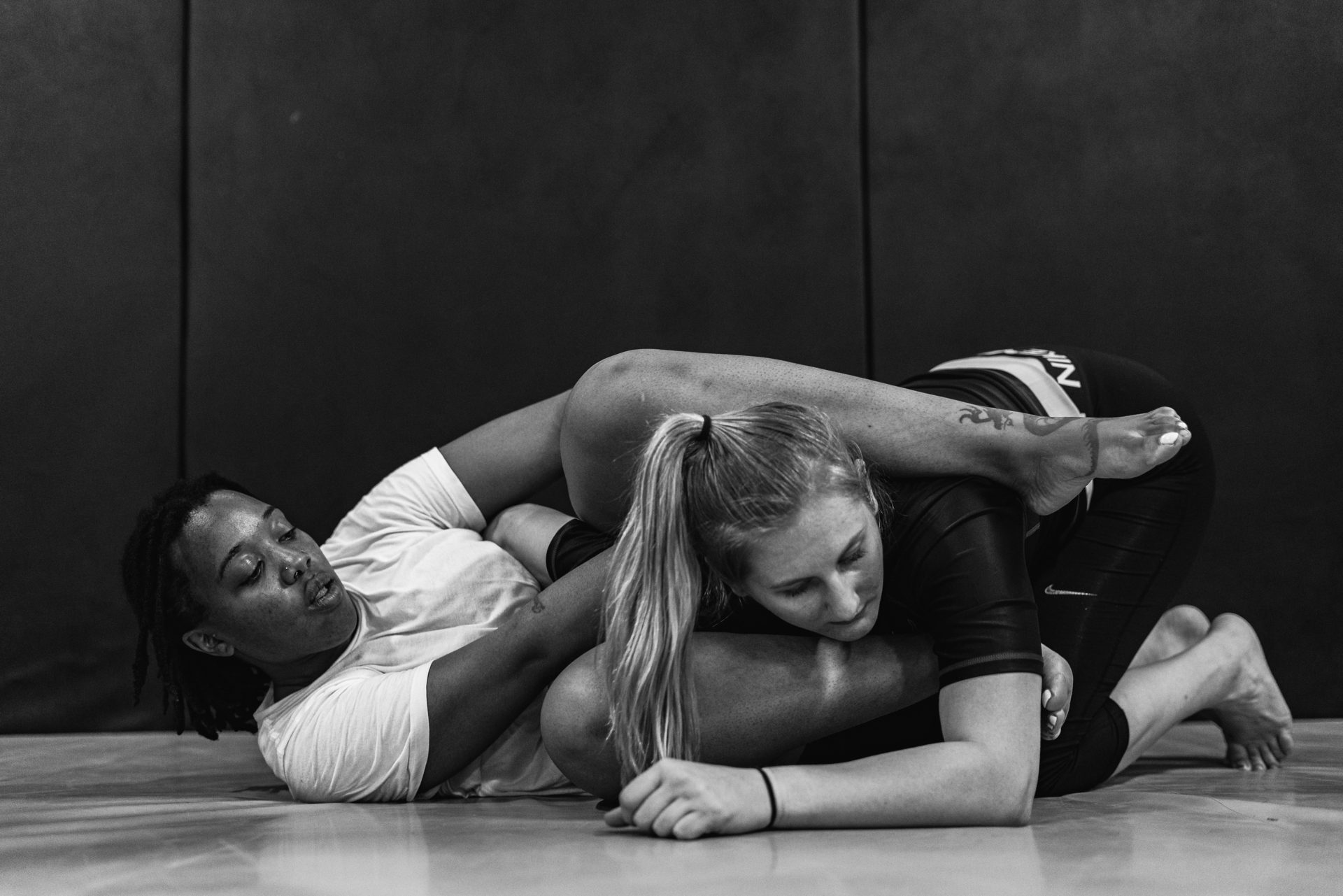 Two students grappling on the mat during live rounds in Cromwell