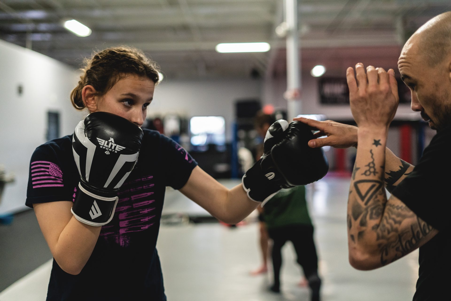 A member with hands up mid-exchange, the coach's glove in frame