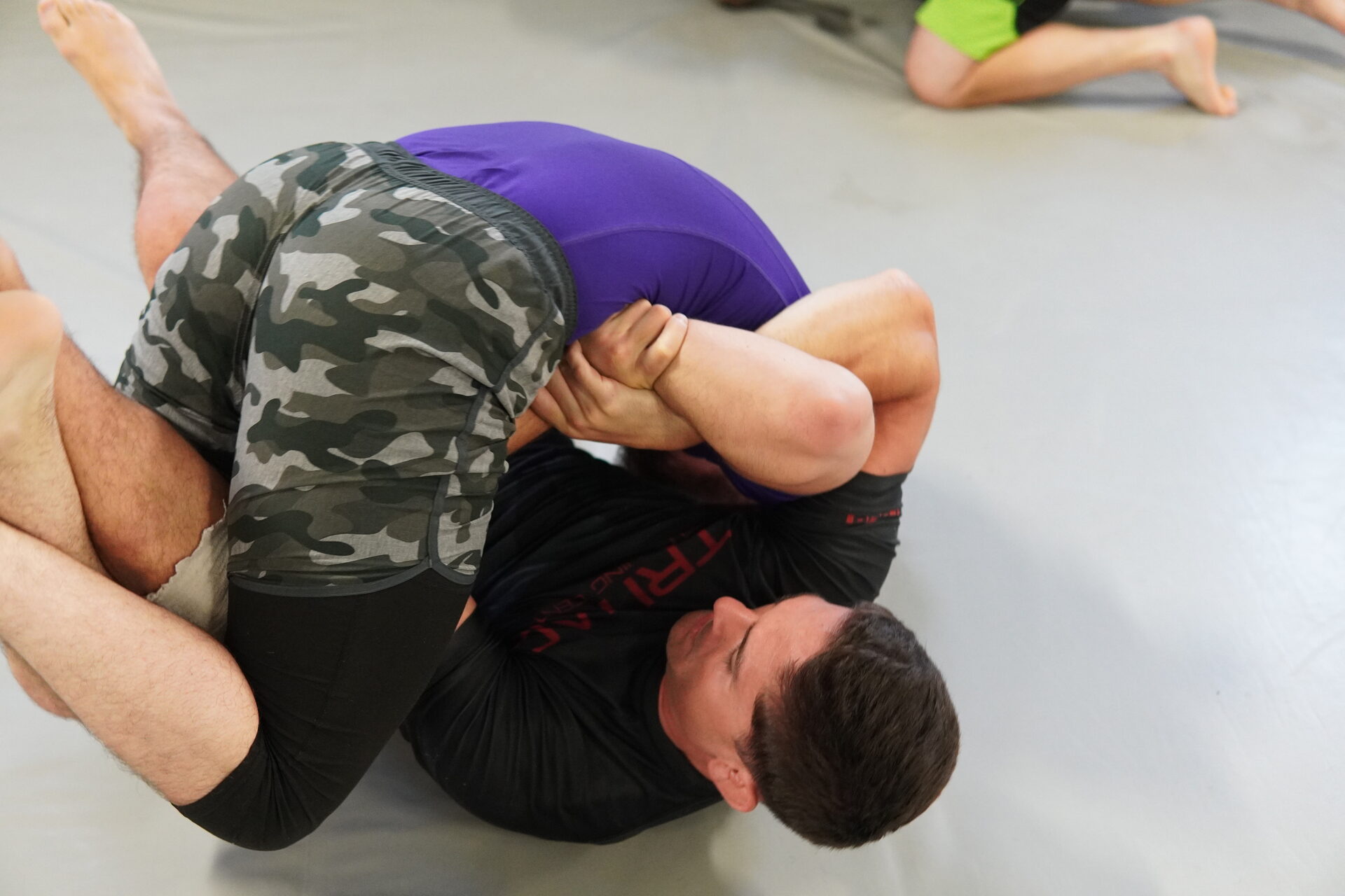 A member holding a pin from the top during ground drilling, shot from above