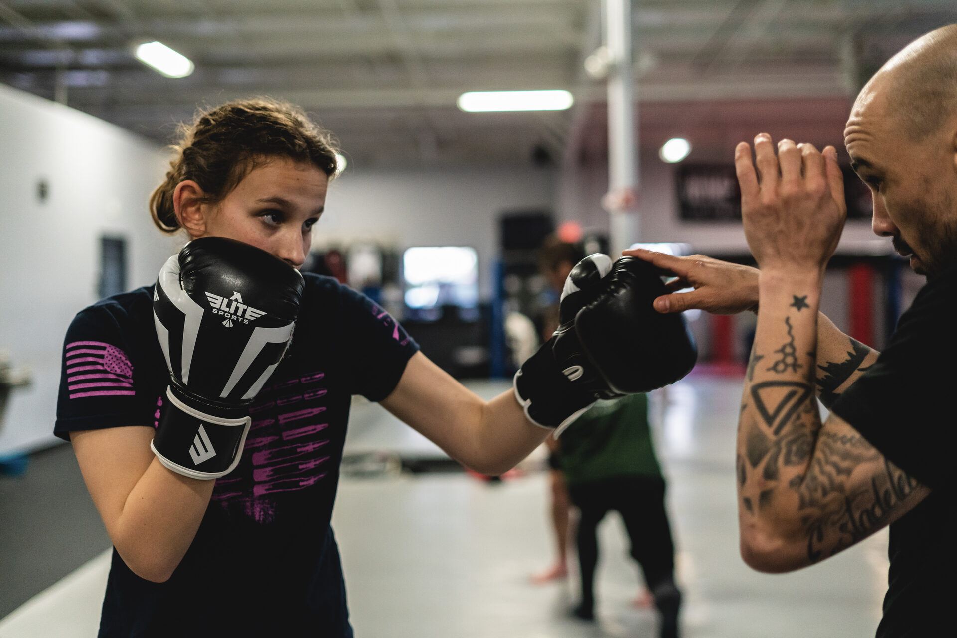 A member with hands up mid-exchange, the coach's glove in frame