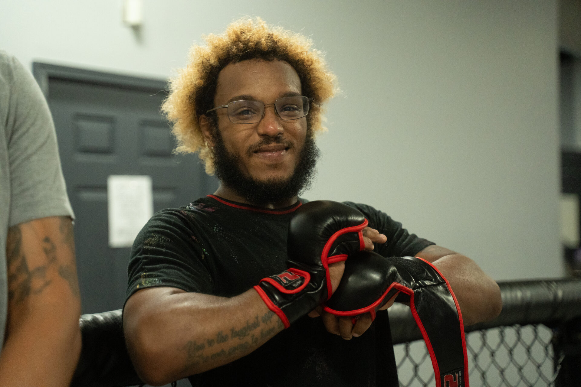 A member at the cage edge with his gloves still on