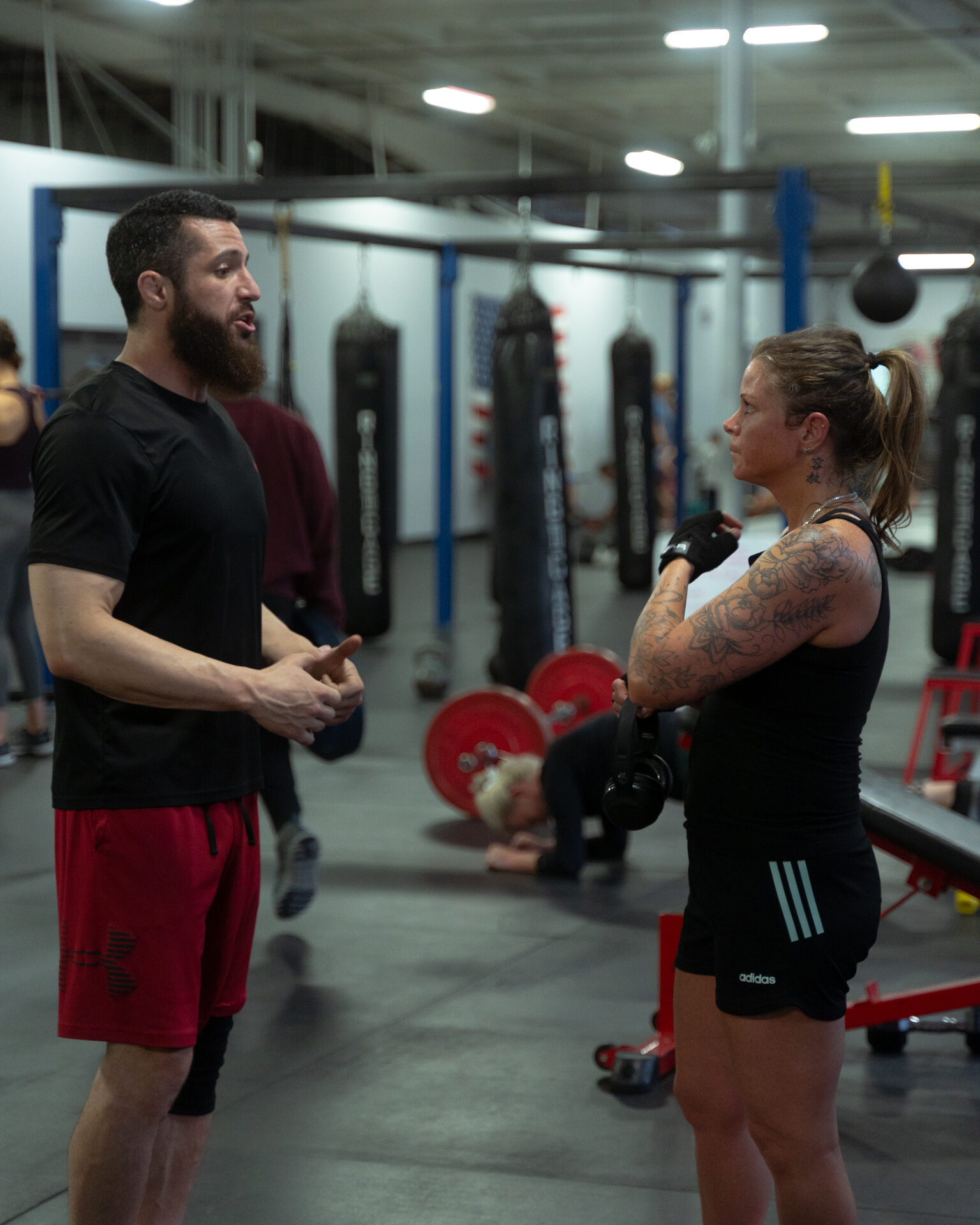One coach working one athlete through a single lift, nobody else in the room